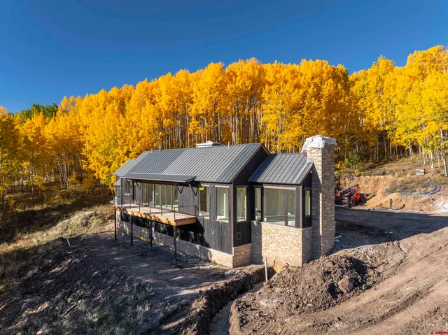 a backyard of a house with table and chairs