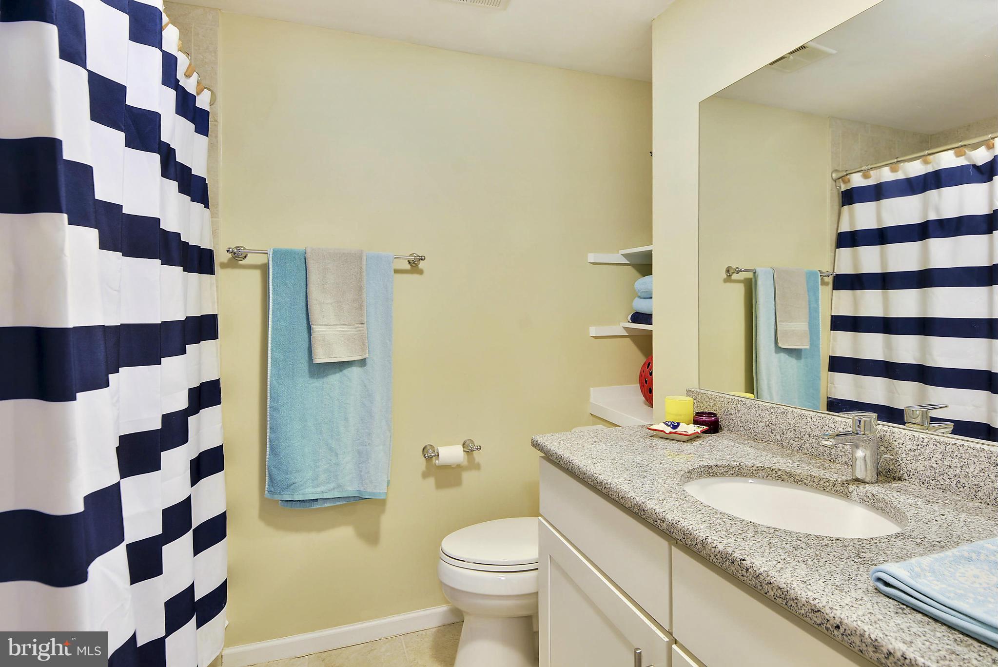 141 Annandale Road Falls Church, VA 22046 - Photo 15 of 30 a bathroom with a granite countertop toilet a sink and a mirror