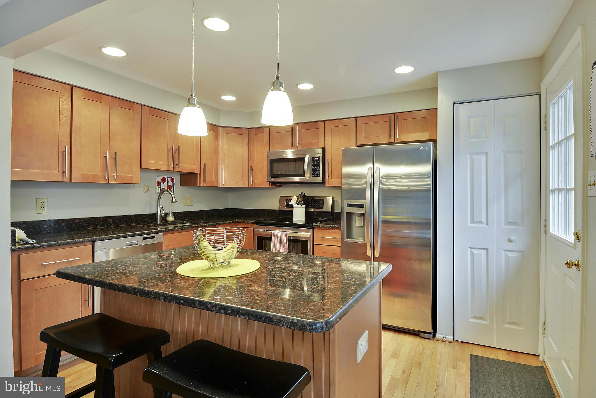 141 Annandale Road Falls Church, VA 22046 - Photo 5 of 30 a kitchen with a refrigerator a stove a sink and a cabinets