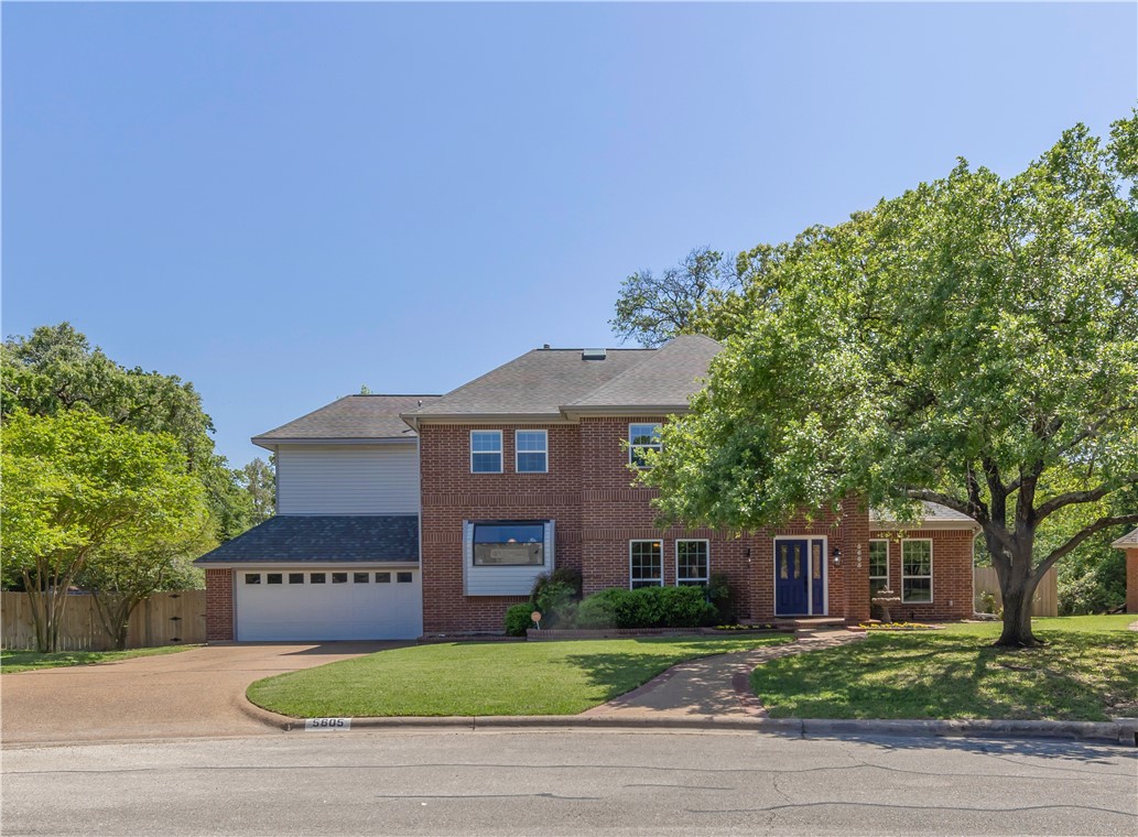 5605 Chelsea Circle Bryan, TX 77802 - Photo 1 of 1 Colonial-style house with a front yard, a shingled