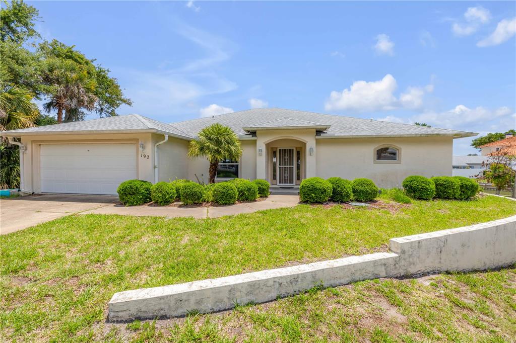 192 Azalea Road Edgewater, FL 32141 - Photo 53 of 94 a front view of a house with garden