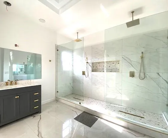 a bathroom with a granite countertop sink mirror and shower