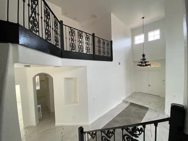 a view of a hallway with entryway and wooden floor