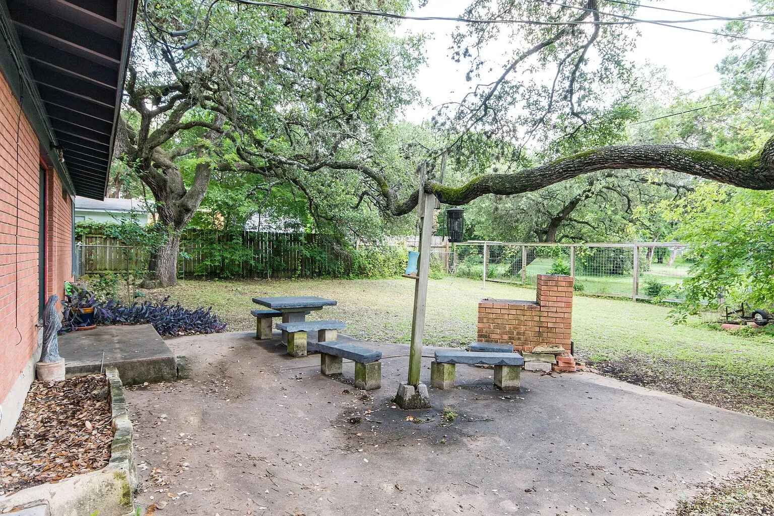 1207 Fieldcrest Drive Austin, TX 78704 - Photo 12 of 13 a backyard of a house with table and chairs