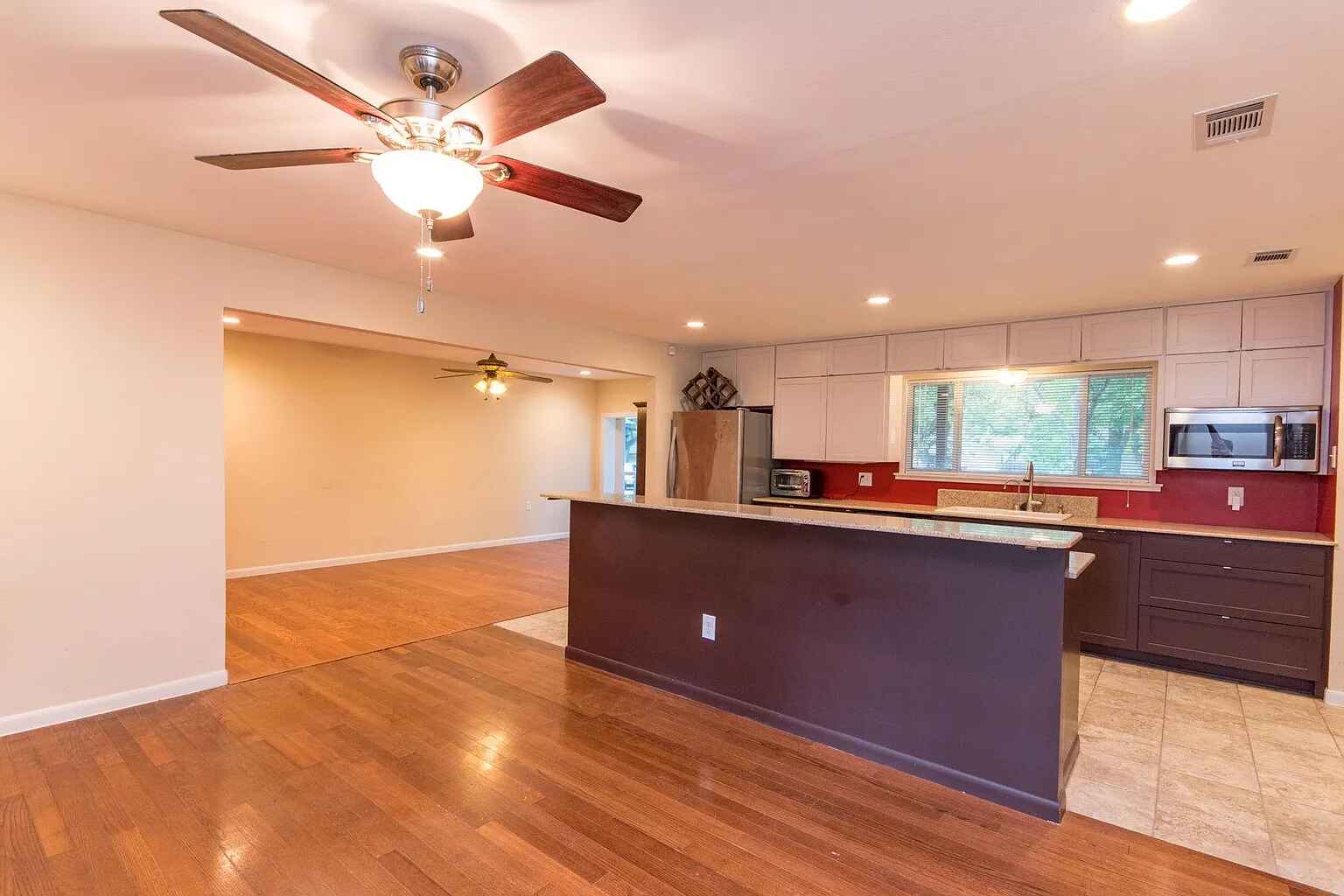 1207 Fieldcrest Drive Austin, TX 78704 - Photo 4 of 13 a living room with couches and kitchen view with wooden floor