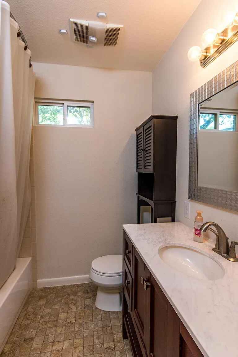 1207 Fieldcrest Drive Austin, TX 78704 - Photo 8 of 13 a bathroom with a sink and a mirror