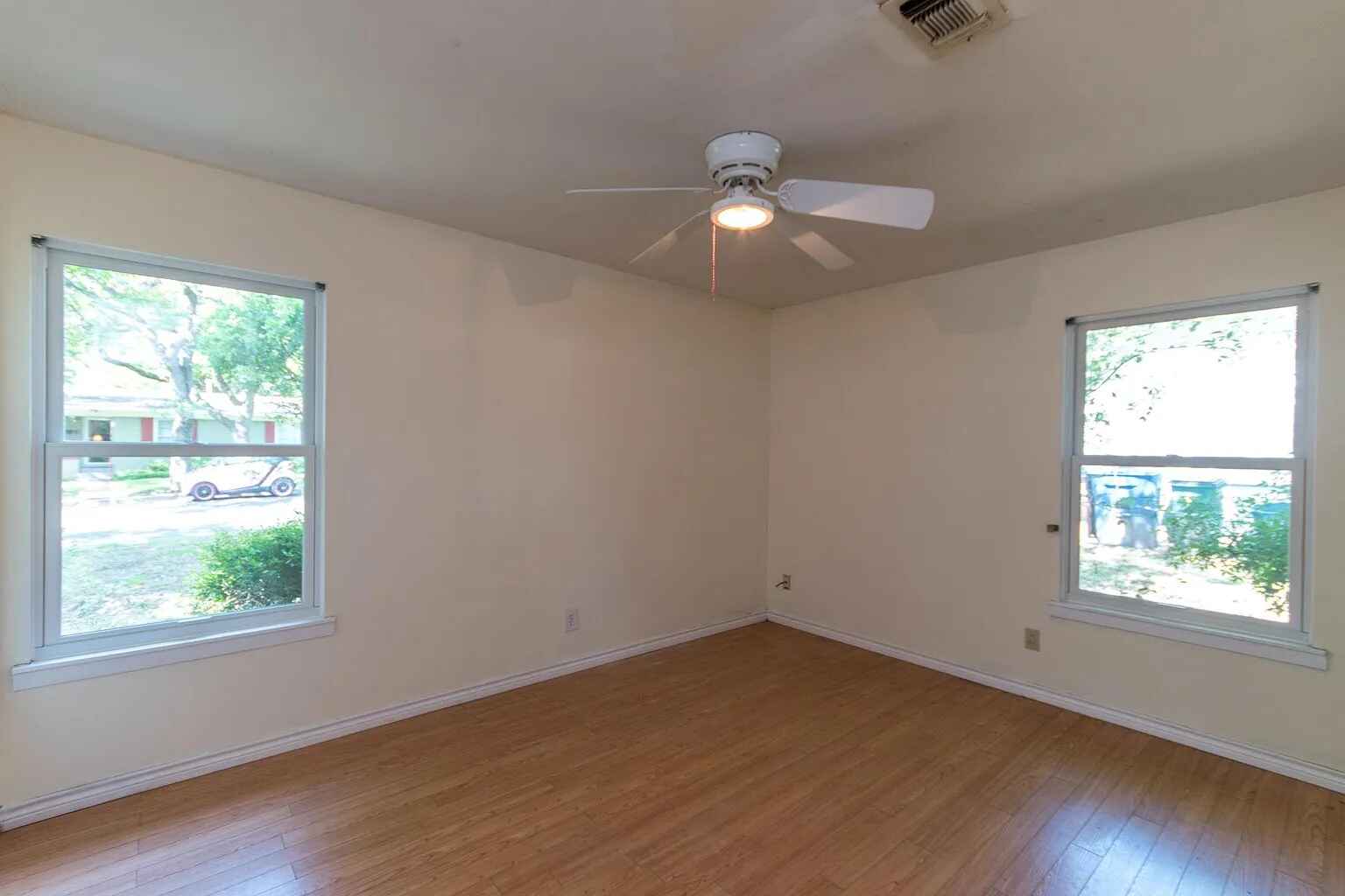 1207 Fieldcrest Drive Austin, TX 78704 - Photo 9 of 13 a view of an empty room with wooden floor and a window