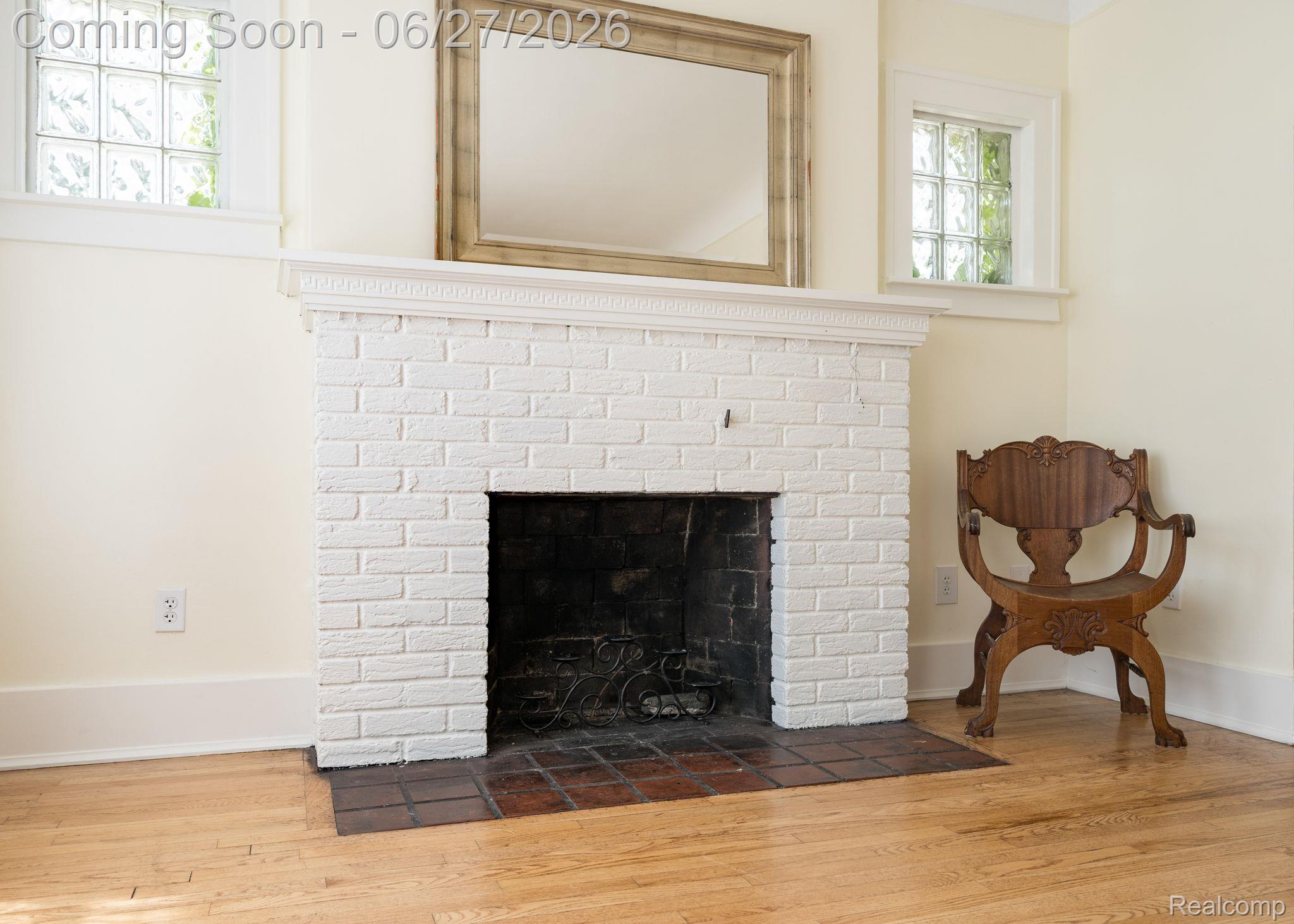 39 Mohawk Road Pontiac, MI 48341 - Photo 8 of 32 Painted brick fireplace with a decorative mantel, set against light-toned walls
