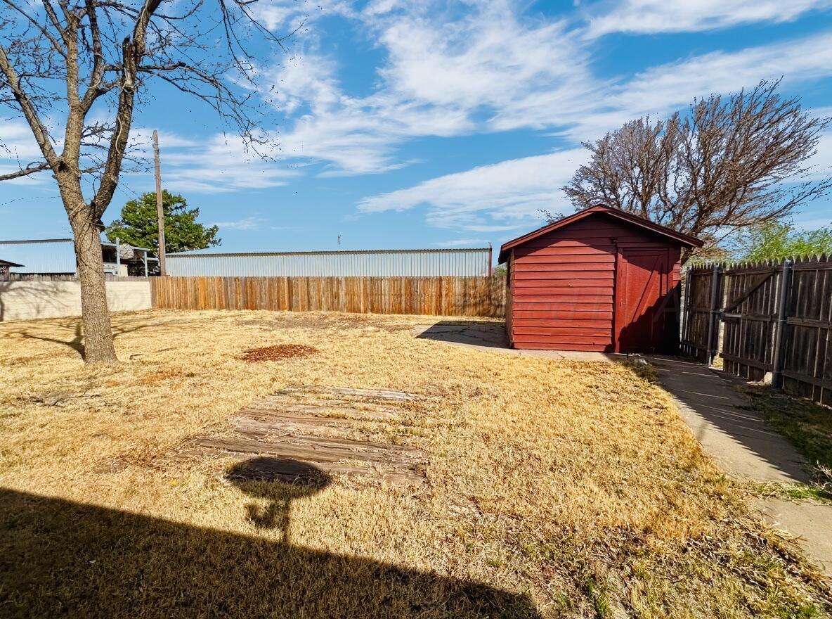 506 Northwest 4th Street Tulia, TX 79088 - Photo 11 of 30 a blue swimming pool with a yard