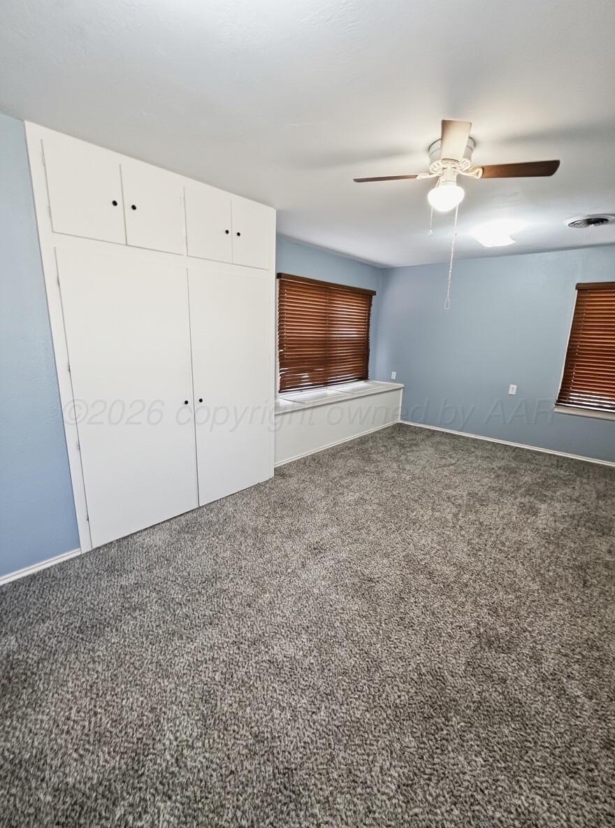 506 Northwest 4th Street Tulia, TX 79088 - Photo 21 of 30 a view of an empty room with a ceiling fan and a window