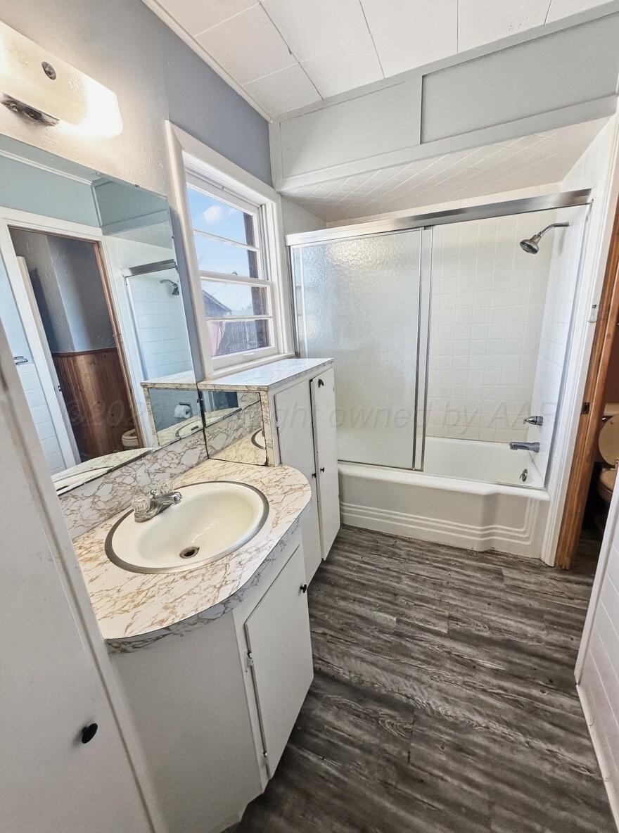 506 Northwest 4th Street Tulia, TX 79088 - Photo 24 of 30 a bathroom with a sink and a mirror