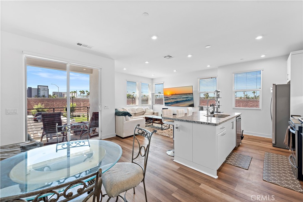 a kitchen with counter space dining table and stainless steel appliances