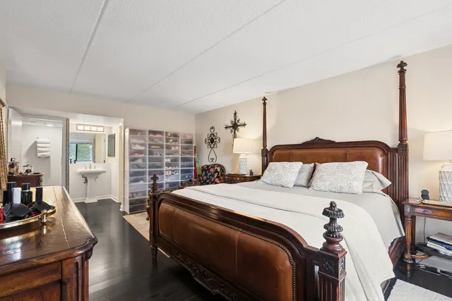 a bed room with a bed window and a chair