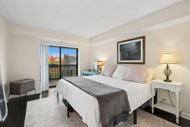 a bedroom with a bed and a lamp next to a window