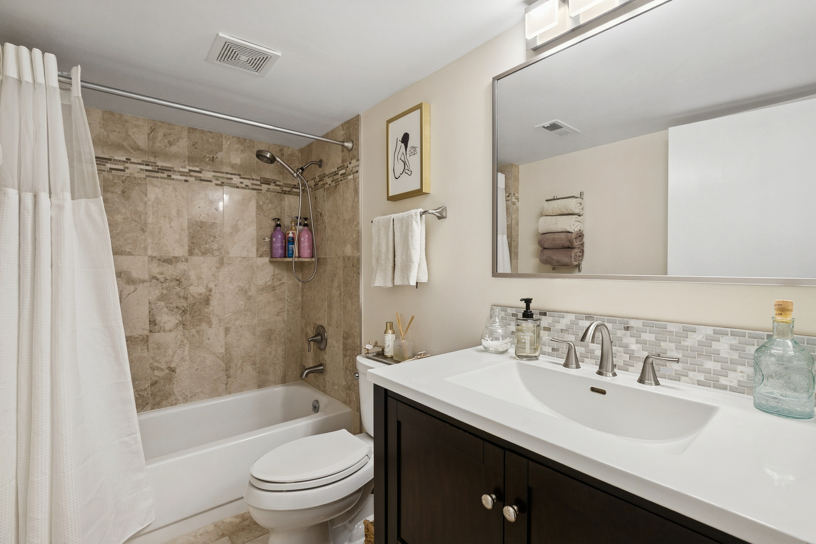 920 Vose Drive, Unit 202 Gurnee, IL 60031 - Photo 18 of 21 a bathroom with a sink a toilet and shower