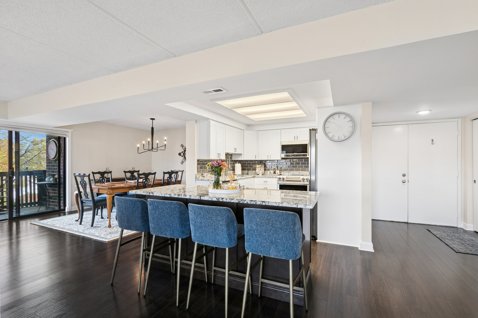 920 Vose Drive, Unit 202 Gurnee, IL 60031 - Photo 4 of 21 a dining room with wooden floor a glass table and chairs