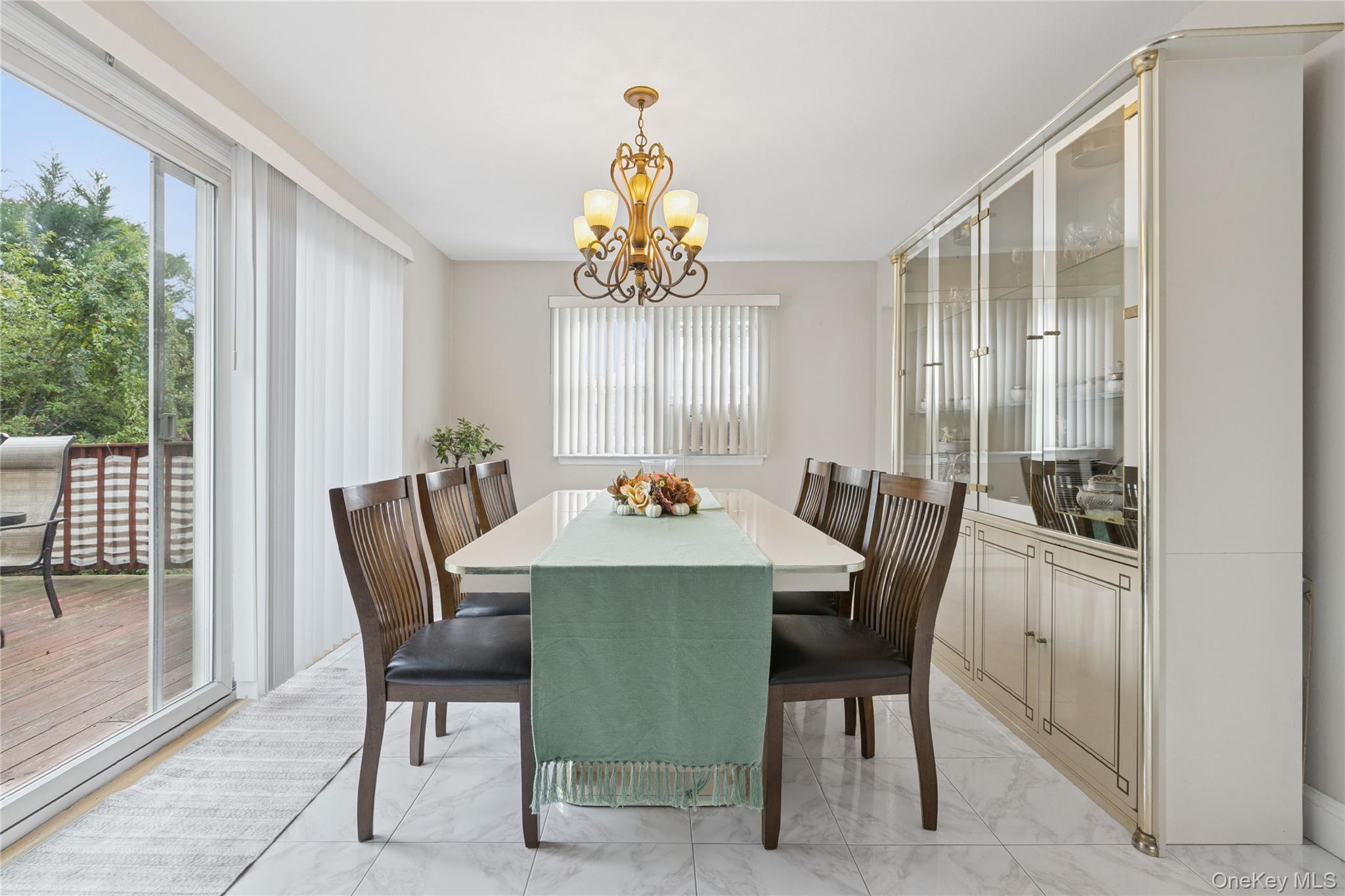 308 Browns Road Nesconset, NY 11767 - Photo 11 of 34 a dining room with furniture a chandelier and wooden floor