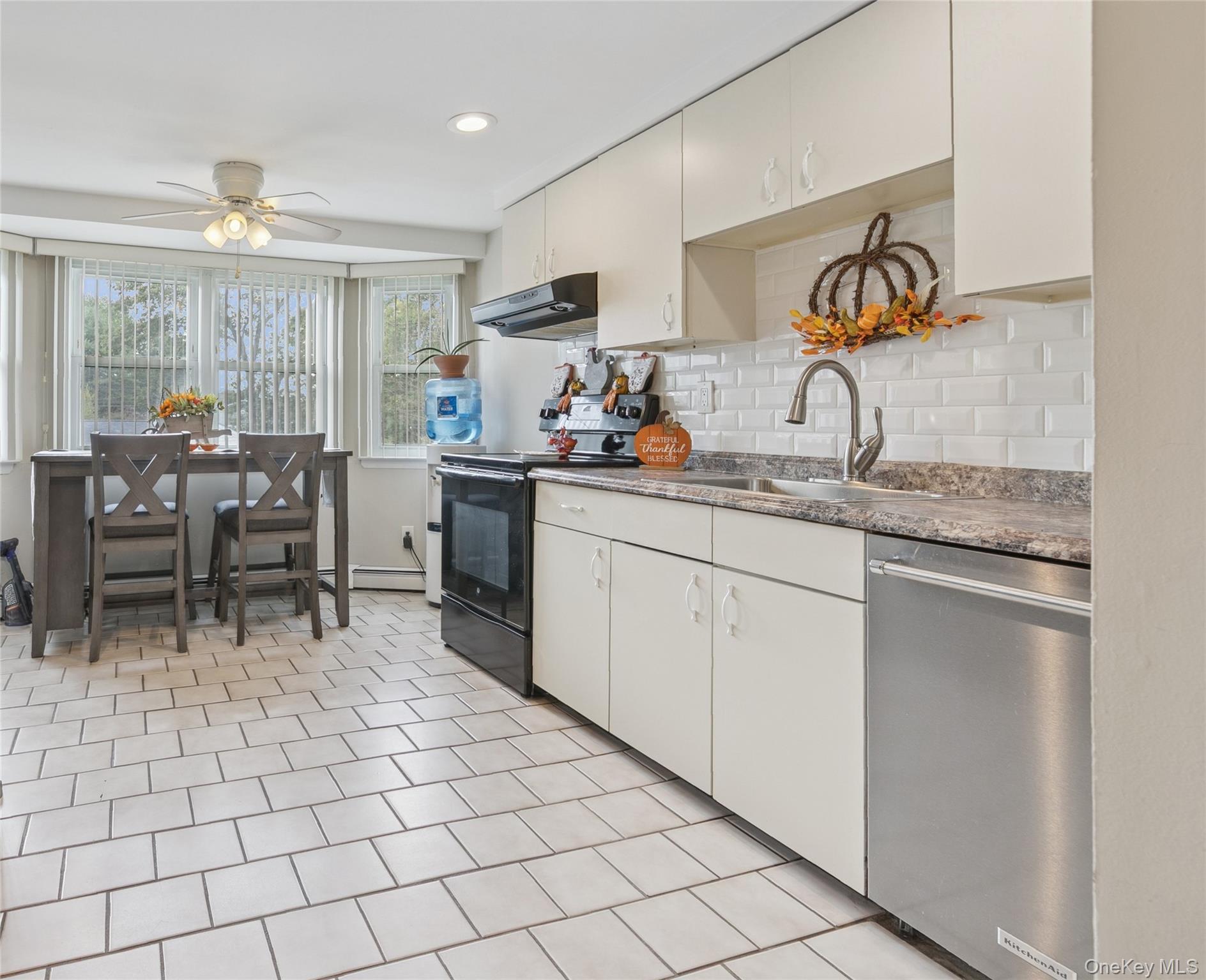 308 Browns Road Nesconset, NY 11767 - Photo 15 of 34 a kitchen with a sink and chairs