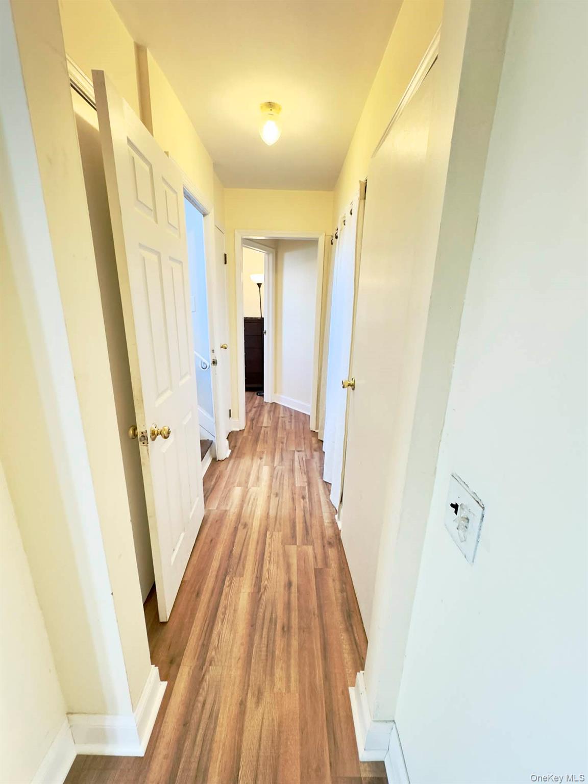 308 Browns Road Nesconset, NY 11767 - Photo 23 of 34 a view of a hallway with wooden floor and staircase