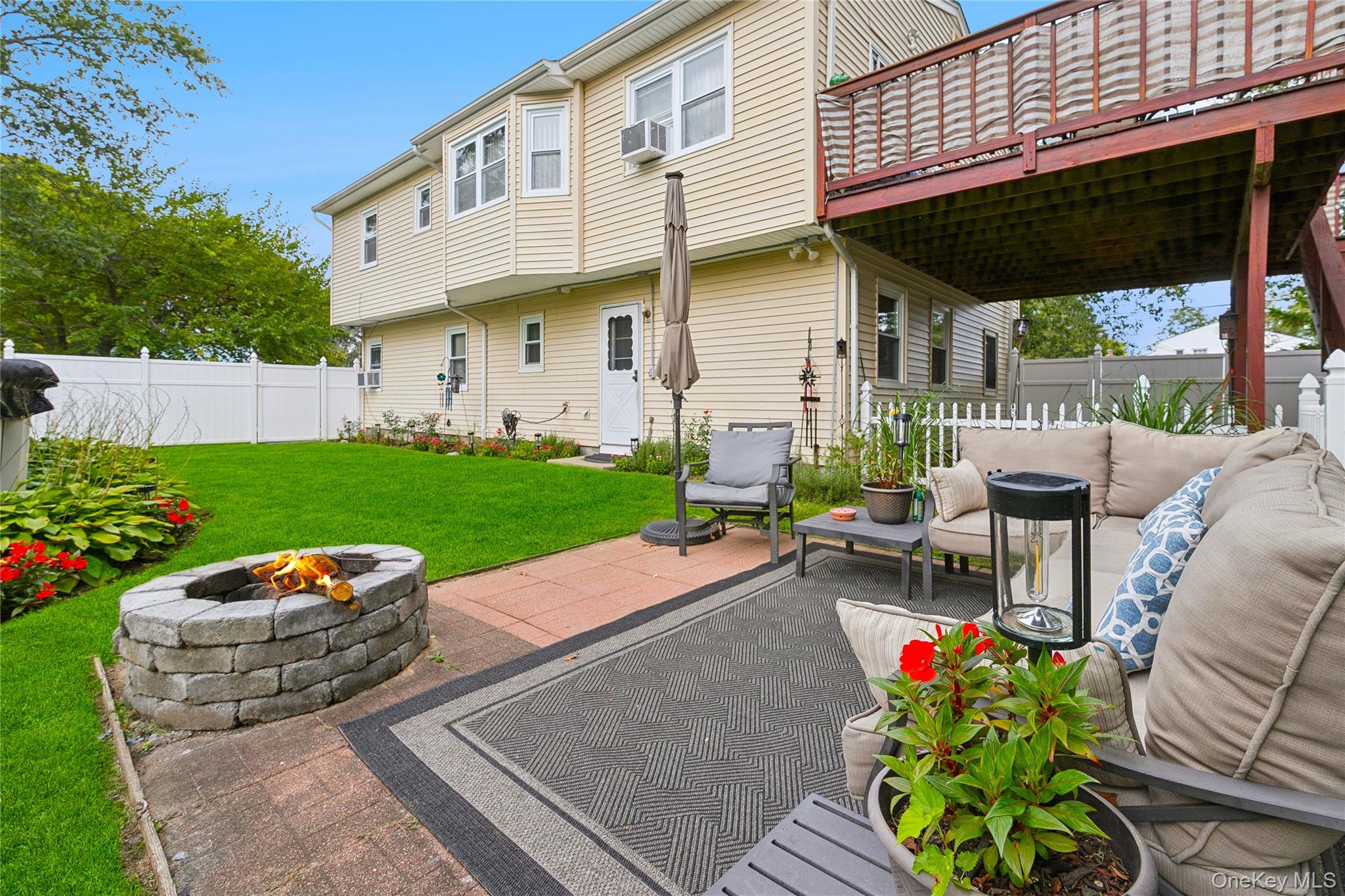 308 Browns Road Nesconset, NY 11767 - Photo 26 of 34 a view of a patio with table and chairs potted plants and a wooden deck