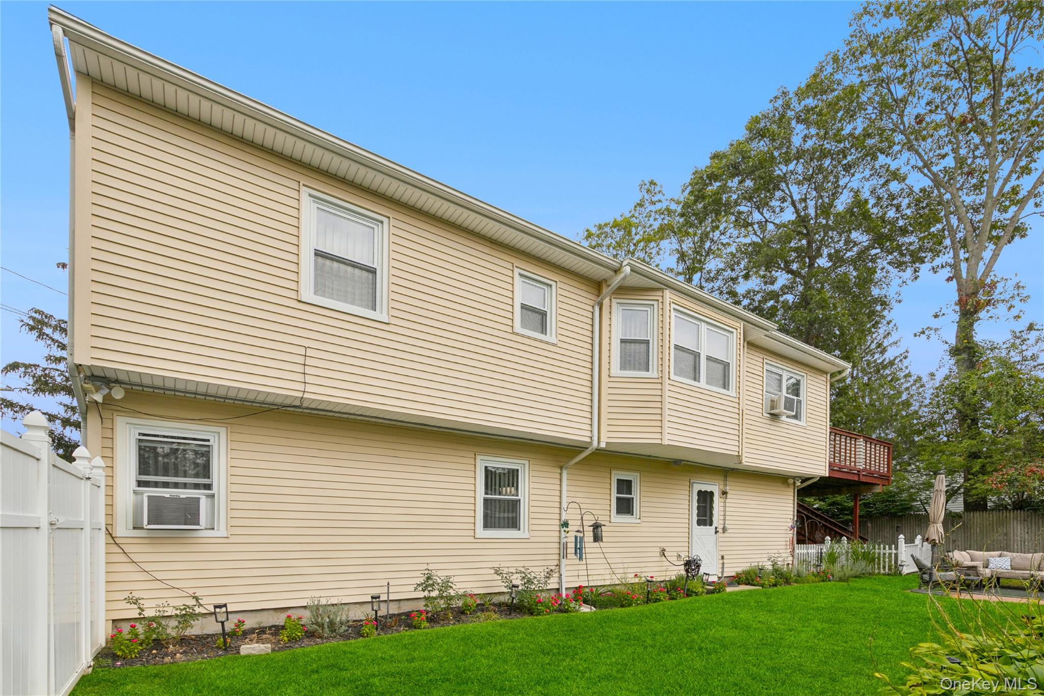 308 Browns Road Nesconset, NY 11767 - Photo 27 of 34 a view of a white house with a yard and a large tree