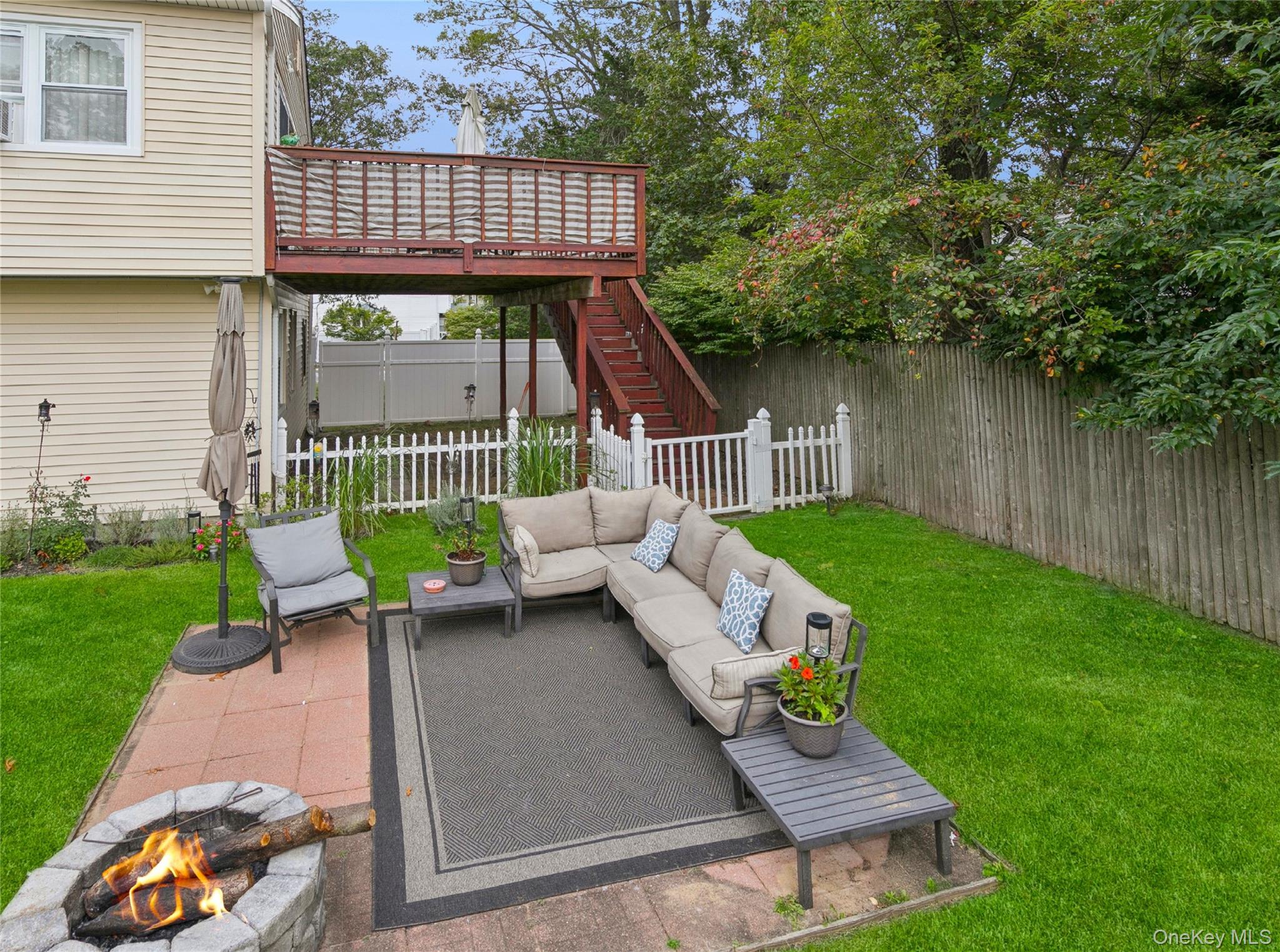 308 Browns Road Nesconset, NY 11767 - Photo 28 of 34 Fenced backyard featuring a patio area, an outdoor living space with a fire pit, a deck, and stairway