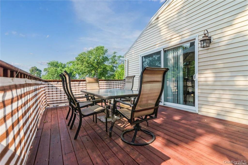 308 Browns Road Nesconset, NY 11767 - Photo 7 of 34 a view of a roof deck with table and chairs and wooden floor
