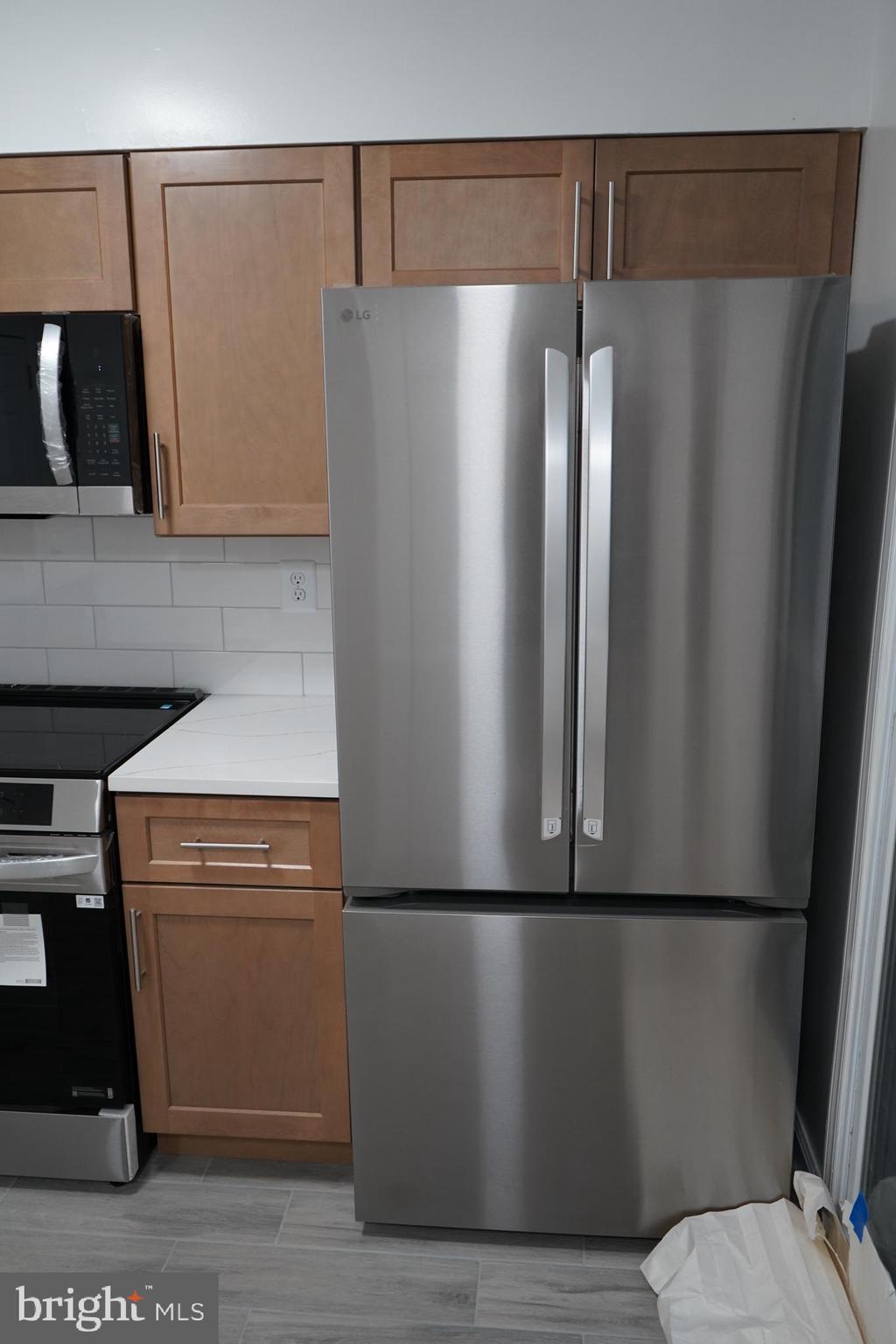 802 West Barre Street Baltimore, MD 21230 - Photo 11 of 72 a kitchen with metallic refrigerator freezer and a dishwasher