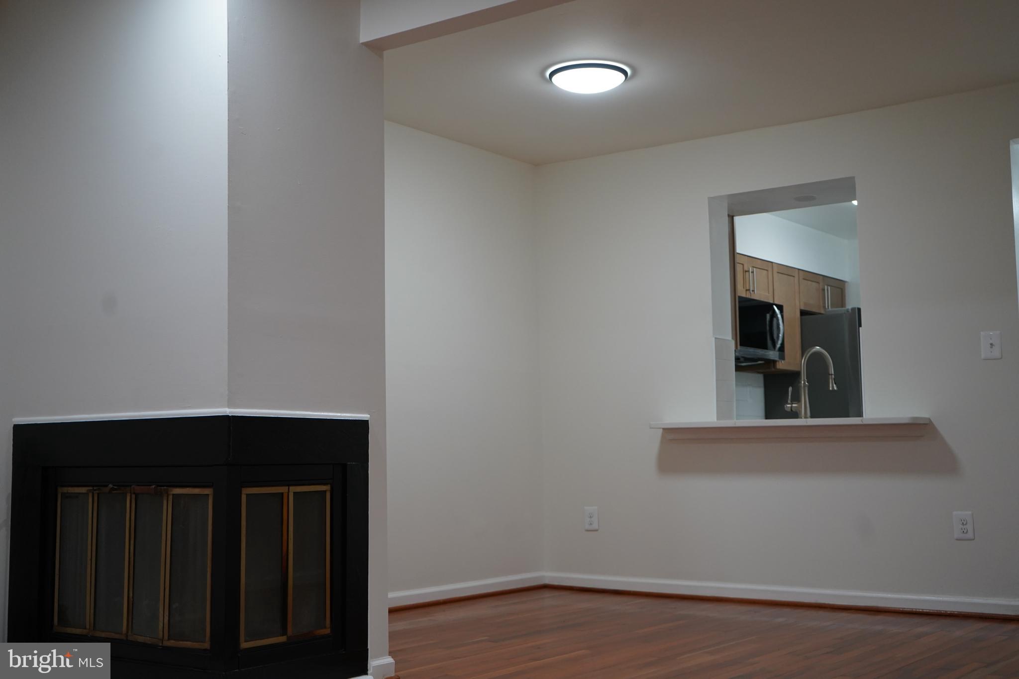 802 West Barre Street Baltimore, MD 21230 - Photo 23 of 72 an empty room with wooden floor and cabinet