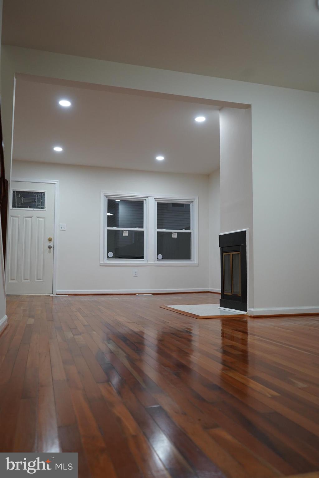 802 West Barre Street Baltimore, MD 21230 - Photo 24 of 72 a view of an empty room with wooden floor and a window