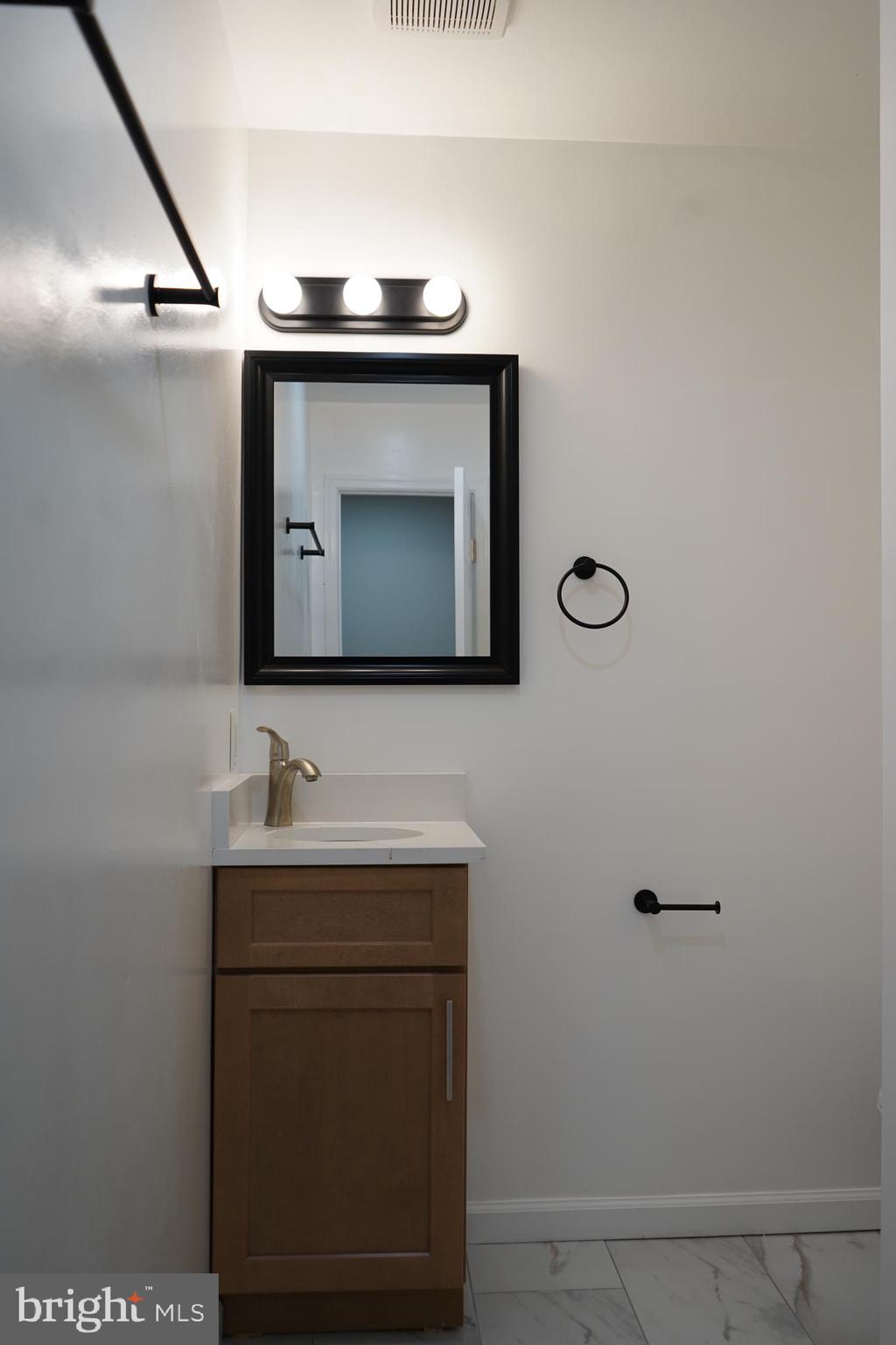 802 West Barre Street Baltimore, MD 21230 - Photo 41 of 72 a bathroom with a toilet sink and mirror