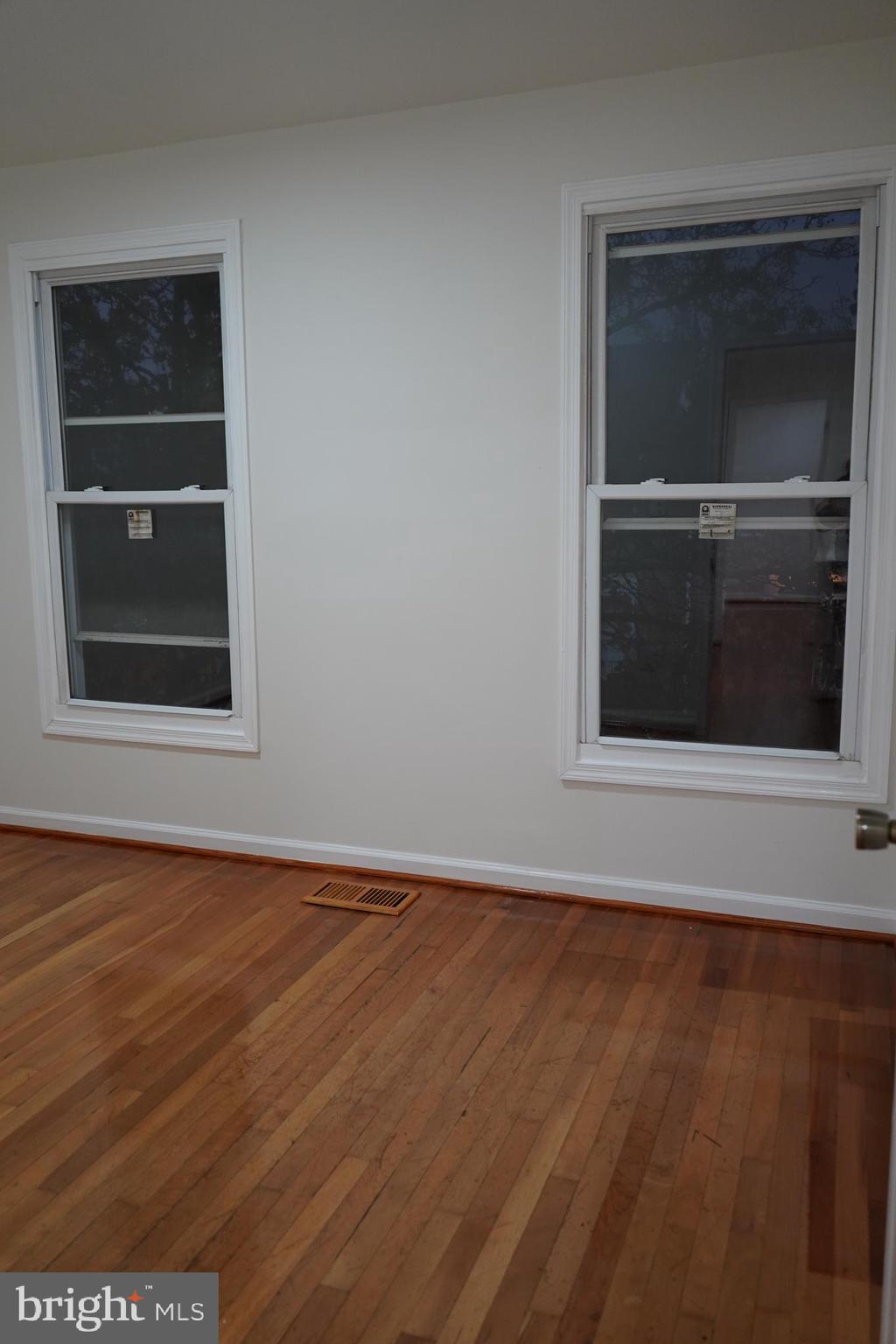 802 West Barre Street Baltimore, MD 21230 - Photo 42 of 72 a view of an empty room with wooden floor and a window