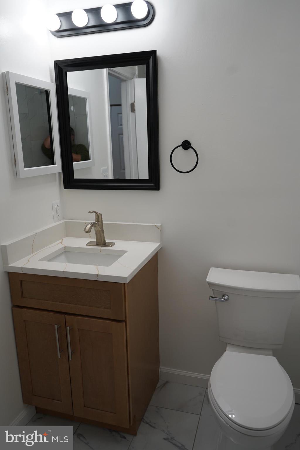 802 West Barre Street Baltimore, MD 21230 - Photo 48 of 72 a bathroom with a toilet sink and mirror