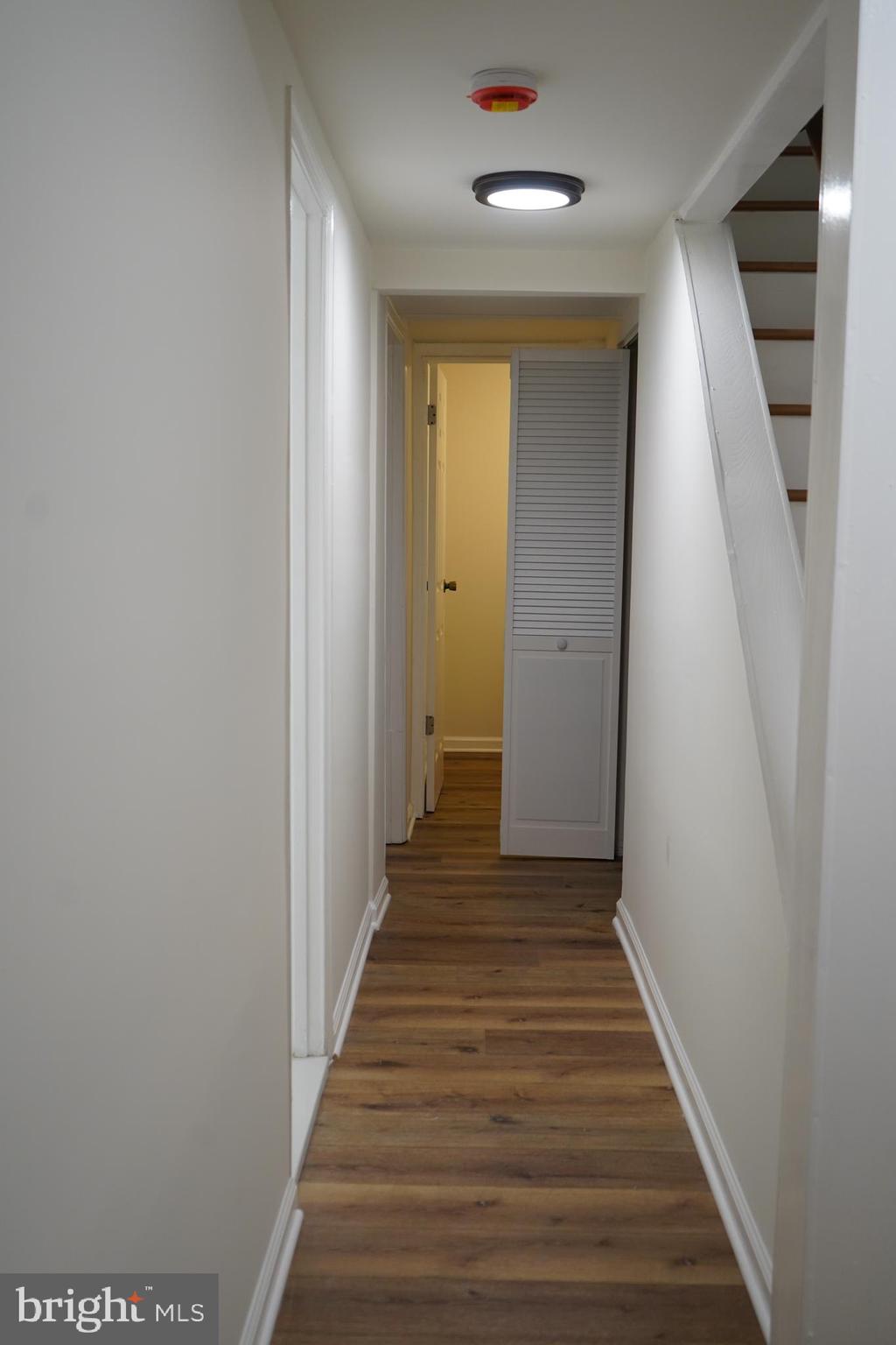 802 West Barre Street Baltimore, MD 21230 - Photo 54 of 72 a view of a hallway with wooden floor and staircase