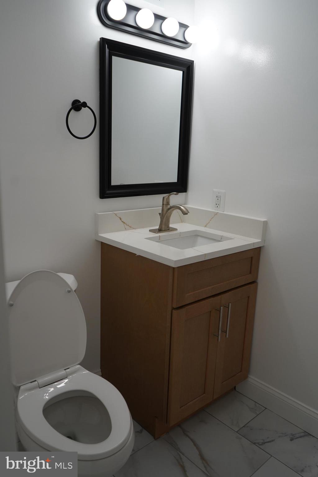 802 West Barre Street Baltimore, MD 21230 - Photo 65 of 72 a bathroom with a toilet sink vanity and mirror