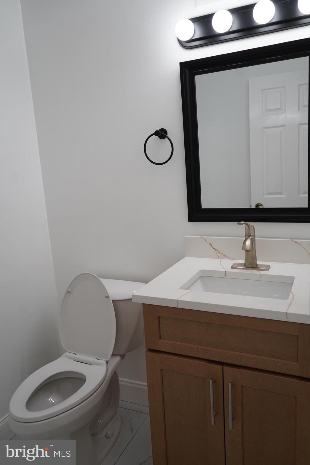 802 West Barre Street Baltimore, MD 21230 - Photo 68 of 72 a bathroom with a sink a toilet and mirror