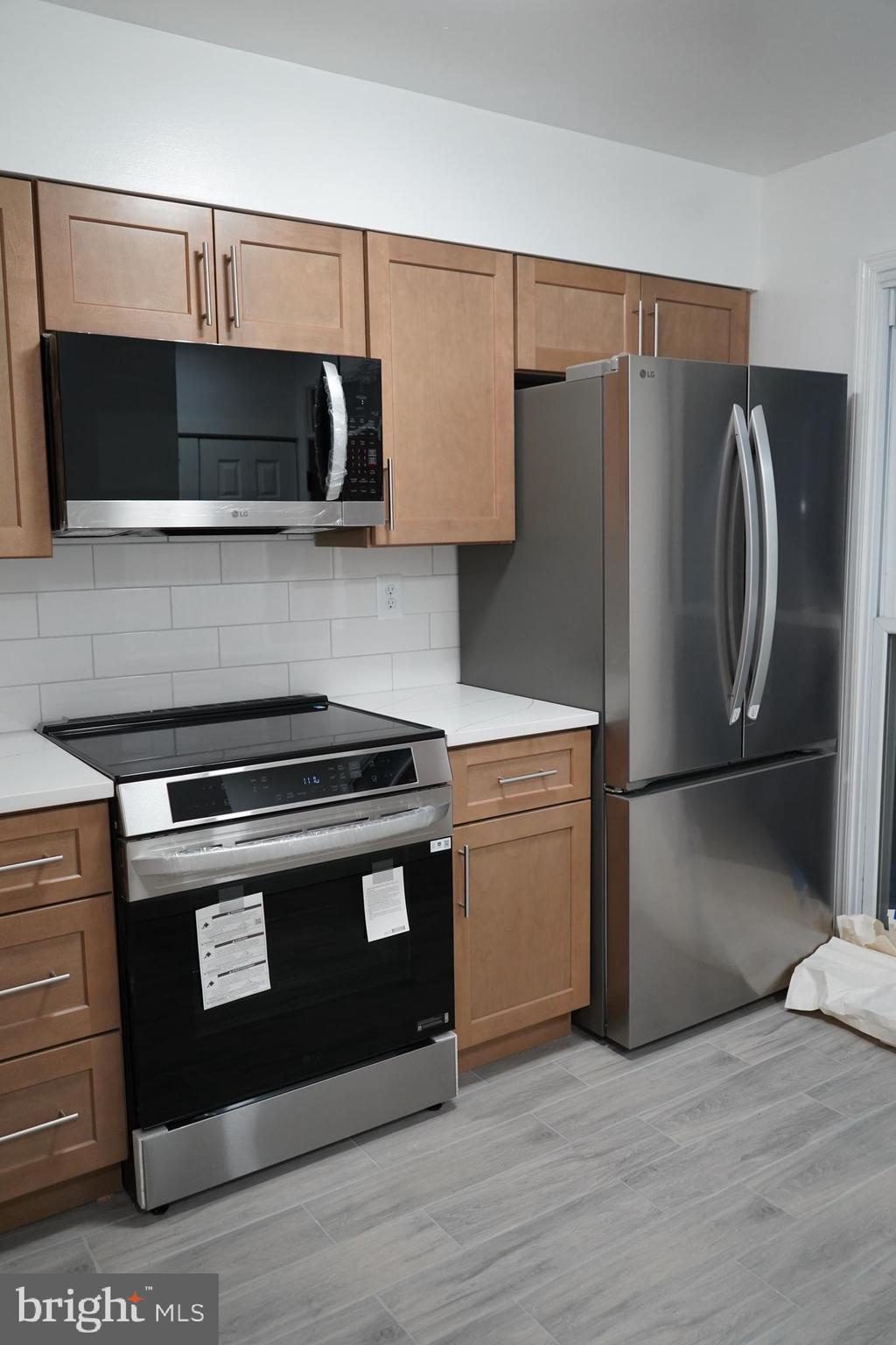 802 West Barre Street Baltimore, MD 21230 - Photo 10 of 72 a kitchen with stainless steel appliances a stove a microwave and a refrigerator