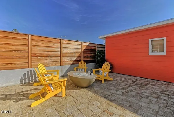 a view of a patio with a table and chairs