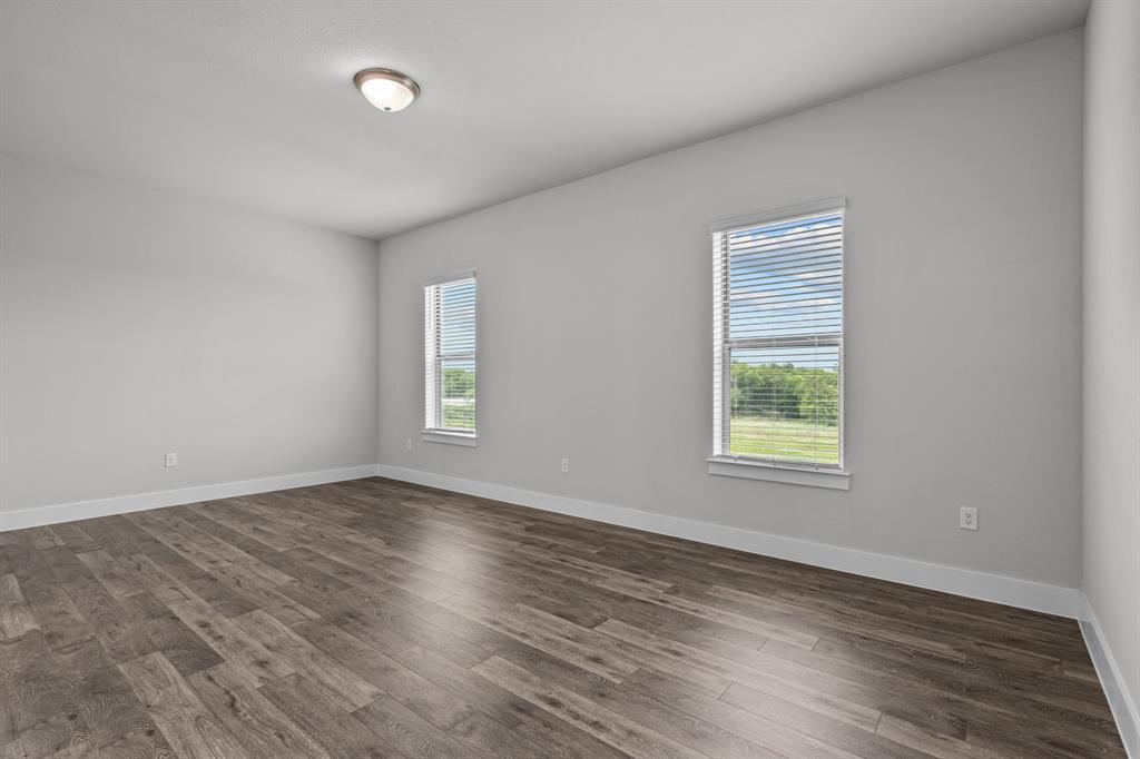 3282 Ganzer Road West, Unit 819B Denton, TX 76207 - Photo 35 of 40 an empty room with wooden floor and windows
