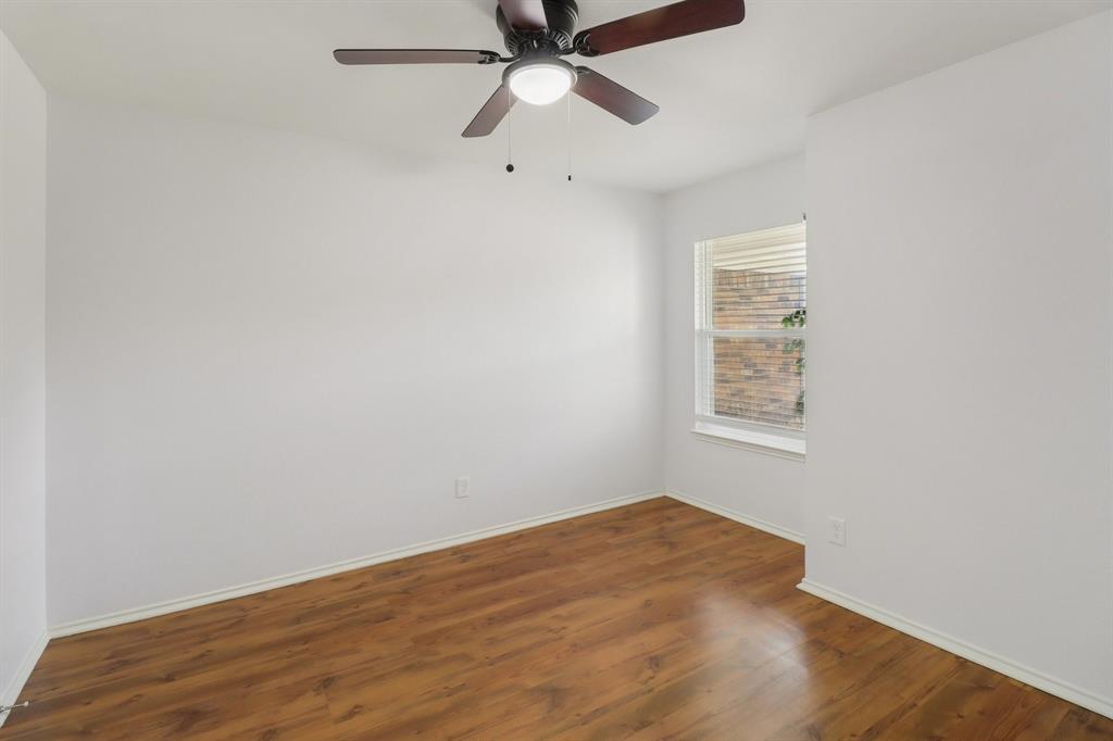 413 Chimney Rock Road Everman, TX 76140 - Photo 15 of 25 an empty room with a window and a fan