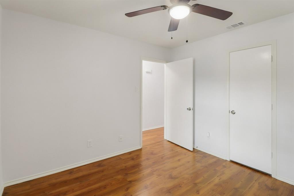 413 Chimney Rock Road Everman, TX 76140 - Photo 16 of 25 a view of an empty room with wooden floor