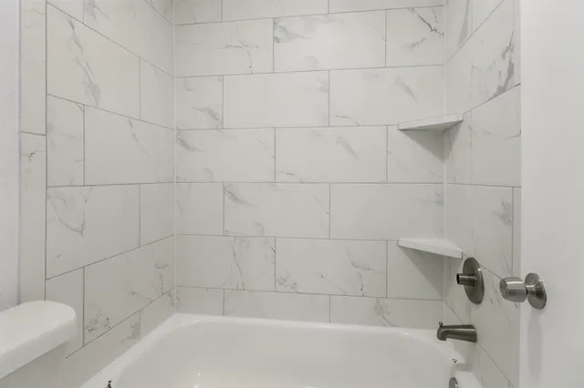 a bathroom with a bathtub and toilet