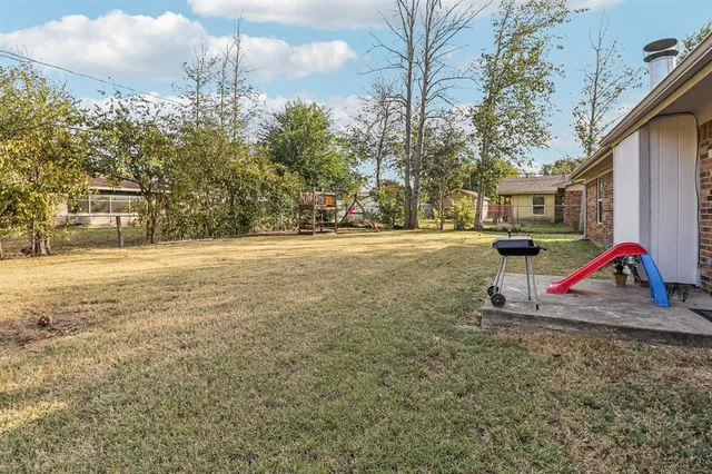 a view of outdoor space with playground and green space