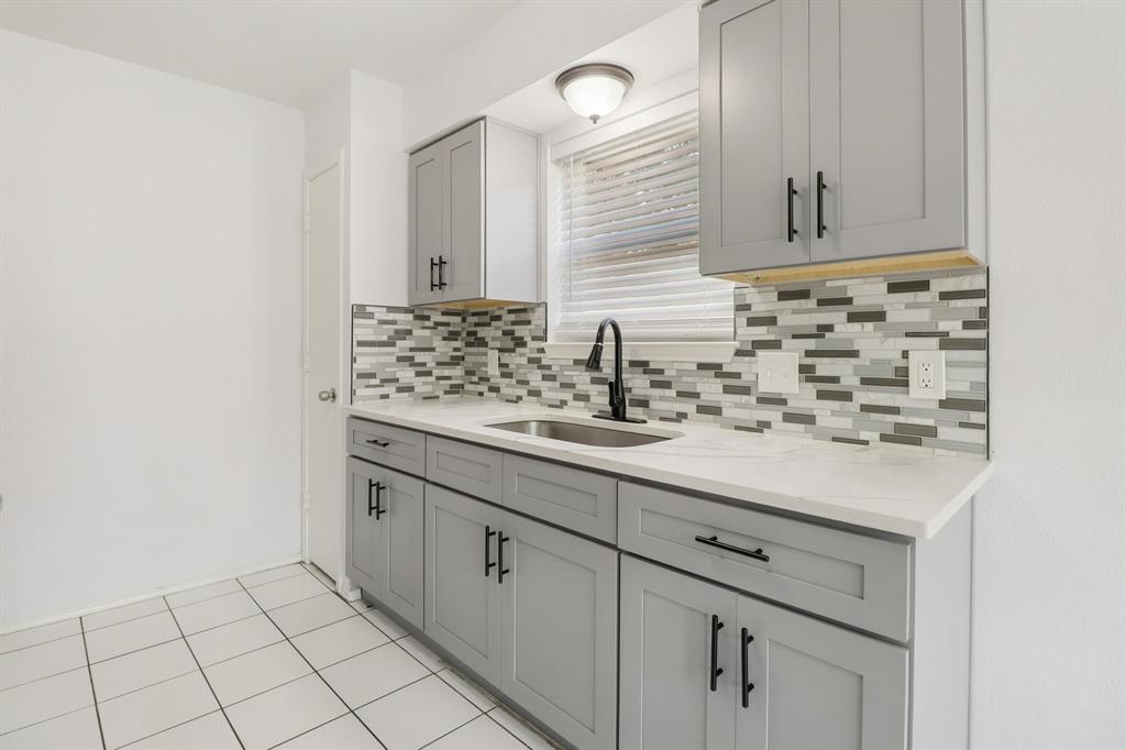 413 Chimney Rock Road Everman, TX 76140 - Photo 10 of 25 a bathroom with a sink and a mirror