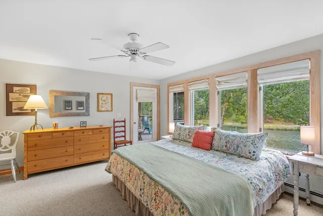 a bedroom with a large bed and a dresser