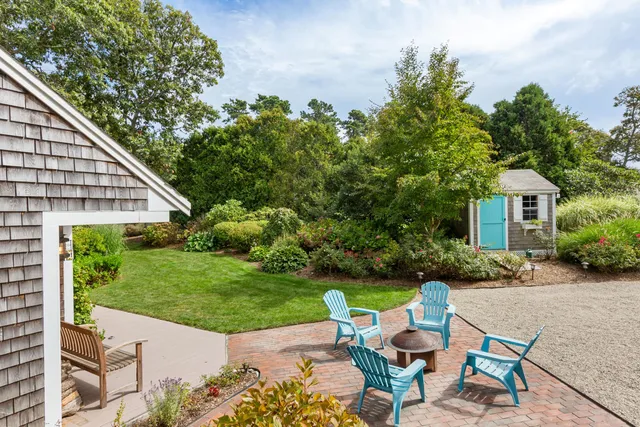 a view of a patio with table and chairs and potted plants