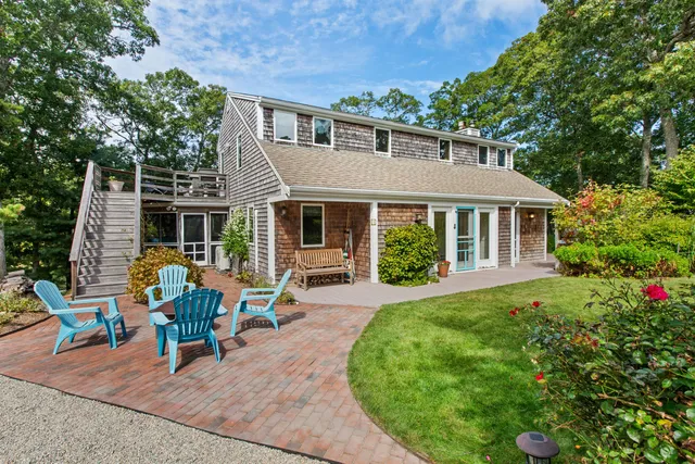 a view of a house with backyard sitting area and garden
