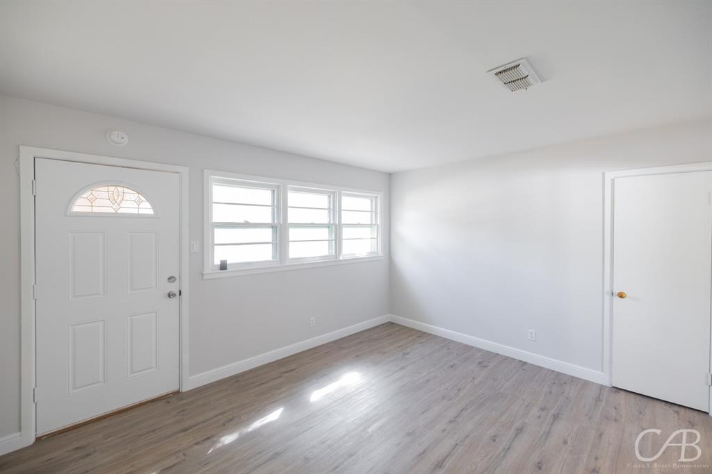 872 Forrest Avenue Abilene, TX 79603 - Photo 15 of 21 an empty room with wooden floor and windows