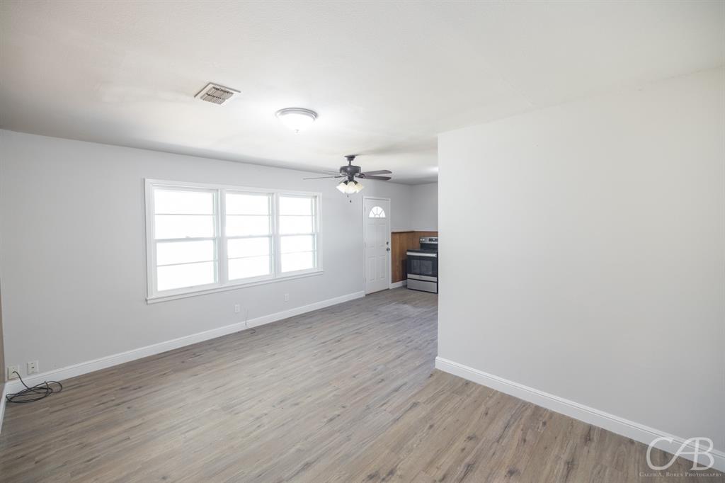 872 Forrest Avenue Abilene, TX 79603 - Photo 16 of 21 wooden floor in an empty room with a window