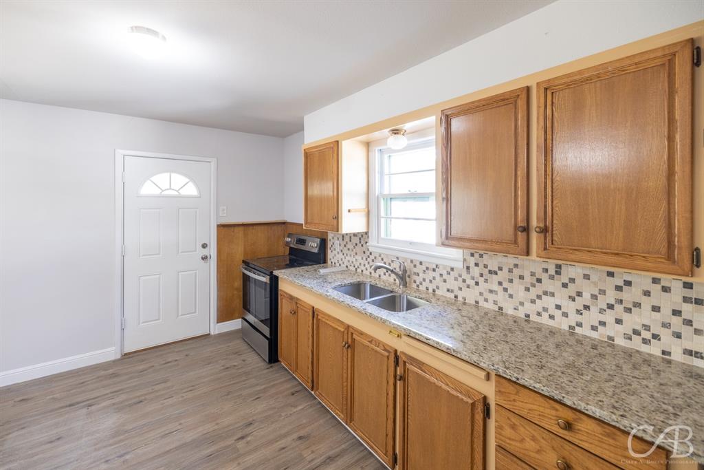 872 Forrest Avenue Abilene, TX 79603 - Photo 20 of 21 a kitchen with stainless steel appliances granite countertop a sink and wooden cabinets